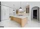 Spacious kitchen with white cabinets, stone countertops, island, and stainless steel appliances at 103 Maddox Rd, Buford, GA 30518