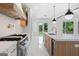 Modern kitchen with stainless steel appliances, a spacious island, and a wine cooler at 103 Maddox Rd, Buford, GA 30518