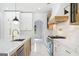 Modern kitchen features white cabinets, marble countertops, and an arched doorway at 103 Maddox Rd, Buford, GA 30518