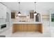 Modern kitchen with center island, marble countertops, custom cabinets, and stainless appliances at 103 Maddox Rd, Buford, GA 30518