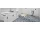 Clean laundry room with white cabinets, stylish tile flooring, and modern fixtures at 103 Maddox Rd, Buford, GA 30518