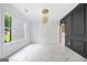 Living room area with black paneling, marble floors, and a modern gold light fixture at 103 Maddox Rd, Buford, GA 30518
