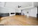 Open-concept living room featuring a sleek fireplace, built-in storage, and a ceiling fan at 103 Maddox Rd, Buford, GA 30518
