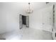 Living room area with black doors, white paneling, marble floors, and a modern light fixture at 103 Maddox Rd, Buford, GA 30518