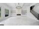 Bright living room with marble floors, modern fireplace, built-in storage, and staircase at 103 Maddox Rd, Buford, GA 30518