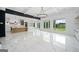 Open-concept living room and kitchen area, featuring marble flooring and an abundance of natural light at 103 Maddox Rd, Buford, GA 30518