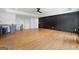 Open-concept living space featuring hardwood flooring and stylish wall paneling at 103 Maddox Rd, Buford, GA 30518