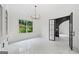 Living room area with black doors, white paneling, marble floors, and a modern light fixture at 103 Maddox Rd, Buford, GA 30518