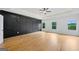 A large bedroom has a dark accent wall with sconces and large windows at 103 Maddox Rd, Buford, GA 30518
