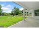 Covered patio that overlooks the expansive backyard with lush green grass and a luxurious pool at 103 Maddox Rd, Buford, GA 30518