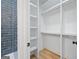Organized walk-in closet featuring built-in shelving and storage for optimal space utilization at 103 Maddox Rd, Buford, GA 30518