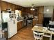 Functional kitchen featuring wooden cabinets, essential appliances, and a dining area for casual meals at 90 Cabriolet Trail, Mcdonough, GA 30253