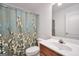 Cozy bathroom with single vanity, floral shower curtain and ample lighting for a functional space at 1335 Vine Cir, Mcdonough, GA 30253