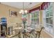 Cozy dining area with a glass table, seating for four, and natural light at 1335 Vine Cir, Mcdonough, GA 30253