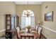 Elegant dining room with a chandelier, large window, and seating for six at 1335 Vine Cir, Mcdonough, GA 30253