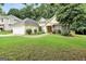 Charming home featuring a well-manicured lawn, mature trees, and a welcoming entrance at 1335 Vine Cir, Mcdonough, GA 30253