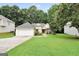 Charming single-story home with a well-manicured lawn and attached two-car garage at 1335 Vine Cir, Mcdonough, GA 30253