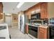 Functional kitchen with oak cabinets, stainless steel refrigerator, and a breakfast bar at 1335 Vine Cir, Mcdonough, GA 30253