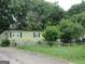 Single-story home featuring exterior shutters and a fenced-in front yard at 4 Skyland W Dr, Locust Grove, GA 30248