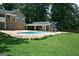 Spacious backyard with an in-ground pool, covered patio, and lush green lawn, ideal for outdoor enjoyment at 565 Scarborough Rd, Ellenwood, GA 30294