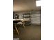 Open basement space features wood-style shelving for storage or display, ready to be transformed at 565 Scarborough Rd, Ellenwood, GA 30294