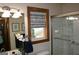 Bright bathroom featuring a wood-framed window and a glass-enclosed shower at 565 Scarborough Rd, Ellenwood, GA 30294