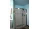 Bathroom featuring a glass-enclosed shower at 565 Scarborough Rd, Ellenwood, GA 30294