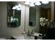Bright bathroom with dual mirrors, a white vanity, and elegant floral accents offers a fresh and clean space at 565 Scarborough Rd, Ellenwood, GA 30294