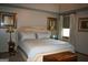 Bright bedroom featuring a neutral color scheme and decorative wall art at 565 Scarborough Rd, Ellenwood, GA 30294