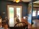 Charming dining room with hardwood floors, ceiling fan, French doors to backyard and view to living room at 565 Scarborough Rd, Ellenwood, GA 30294