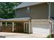 Exterior of home showing a covered patio, garage, and backyard access, combining functionality and outdoor living at 565 Scarborough Rd, Ellenwood, GA 30294