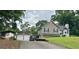 Spacious home exterior with a driveway, detached garage, and metal carport perfect for extra storage at 565 Scarborough Rd, Ellenwood, GA 30294