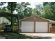Two-car garage with a double wide driveway and a carport provides convenient parking and storage at 565 Scarborough Rd, Ellenwood, GA 30294