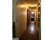 Long hallway with hardwood floors leads to bathroom and bedrooms, offering a glimpse of the home's layout at 565 Scarborough Rd, Ellenwood, GA 30294