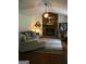 Cozy living room features a stone fireplace, ceiling fan, neutral walls, and comfortable furniture at 565 Scarborough Rd, Ellenwood, GA 30294