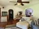 Bright living room featuring multiple archways, neutral paint, ceiling fan, and comfortable seating arrangement at 565 Scarborough Rd, Ellenwood, GA 30294