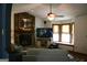 Bright living room with stone fireplace, large bay window, ceiling fan, and comfortable seating at 565 Scarborough Rd, Ellenwood, GA 30294