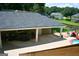 Covered patio with outdoor seating, a playset, and pool access, perfect for entertaining and relaxation at 565 Scarborough Rd, Ellenwood, GA 30294
