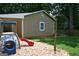 Backyard with a playset and storage shed at 565 Scarborough Rd, Ellenwood, GA 30294