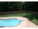 Large in-ground pool with diving board, surrounded by a concrete patio and landscaping, perfect for summer fun at 565 Scarborough Rd, Ellenwood, GA 30294