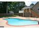 Backyard with a refreshing in-ground pool, diving board, and patio area, creating a private outdoor oasis at 565 Scarborough Rd, Ellenwood, GA 30294