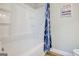 Clean and functional white tub and shower combination with stylish blue patterned curtain at 24317 Plantation Ne Dr, Atlanta, GA 30324