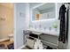 Modern bathroom with vanity, decorative mirror, updated sink, and storage shelves at 24317 Plantation Ne Dr, Atlanta, GA 30324