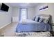 Comfortable bedroom featuring a bed with blue bedding, natural light, and stylish decor at 24317 Plantation Ne Dr, Atlanta, GA 30324