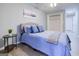Relaxing bedroom with blue bedding, a side table, and decorative wall art above the bed at 24317 Plantation Ne Dr, Atlanta, GA 30324