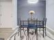 Bright dining area with a glass table set, decorative rug, and modern lighting fixture at 24317 Plantation Ne Dr, Atlanta, GA 30324