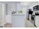 Open concept kitchen with white cabinetry, stainless steel appliances, and breakfast bar at 24317 Plantation Ne Dr, Atlanta, GA 30324