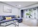 Bright living room featuring a sectional sofa, modern decor, and ample natural light at 24317 Plantation Ne Dr, Atlanta, GA 30324