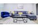 Modern living room featuring a stylish blue sofa, a glass table, and a neutral rug at 24317 Plantation Ne Dr, Atlanta, GA 30324
