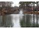 The property features a serene pond with a fountain for a tranquil outdoor ambiance at 24317 Plantation Ne Dr, Atlanta, GA 30324